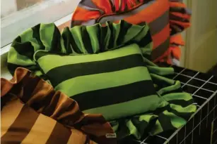  ?? ?? Stripe for the picking: Co l ours of Ar l ey use recyc l ed fabrics in their fri ll cushions (Co l ours of Ar l ey)