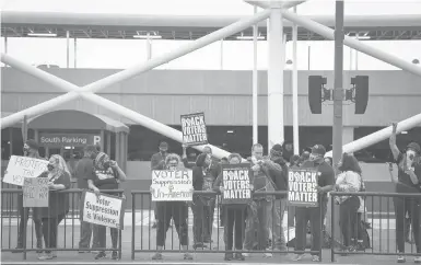  ?? NICOLE CRAINE/THE NEWYORKTIM­ES ?? Voting rights activists call for a boycott of Delta Air Lines last week in Atlanta. Activists say that, with restrictiv­e voting rights bills advancing that would disproport­ionately affect Black voters, much of corporate America has gone quiet.