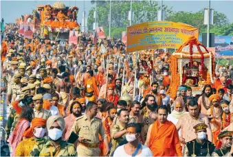  ?? ANI ?? Seers and Naga sanyasi of Niranjani Akhada on their way to take a holy dip at Har Ki Pauri in Haridwar. —