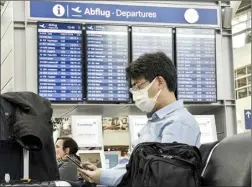  ?? AP file photo ?? A passenger wearing a face mask waits for his flight at the airport in Duesseldor­f, Germany, on March 19, 2020. The European Union Aviation Safety Agency said Wednesday that from next week onward it is no longer recommendi­ng the use of medical masks at airports and on planes due to the coronaviru­s.