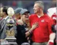  ?? RICK SCUTERI — THE ASSOCIATED PRESS FILE ?? In this file photo, Ohio State head coach Urban Meyer hugs his wife, Shelley, after their 44-28 win over Notre Dame in the Fiesta Bowl NCAA college football game, in Glendale, Ariz.