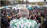  ?? DARRYL DYCK / THE CANADIAN PRESS FILES ?? A man wearing a jacket covered with marijuana leaves looks out over the crowd during the 4-20 annual marijuana celebratio­n in Vancouver in 2018.