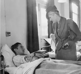  ??  ?? Pauline Vanier visits with a wounded soldier at No. 17 Canadian General Hospital, Pinewood, England, in 1943.