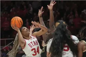  ?? RICK BOWMER — THE ASSOCIATED PRESS ?? Utah forward Dasia Young, left, takes the game-winning shot as Colorado center Aaronette Vonleh defends on Friday in Salt Lake City.