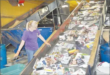  ??  ?? Tricia Stout sorts through magazines moving into a baler at the Bella Vista Recycling Center. (NWA Democrat-Gazette/Rachel Dickerson)