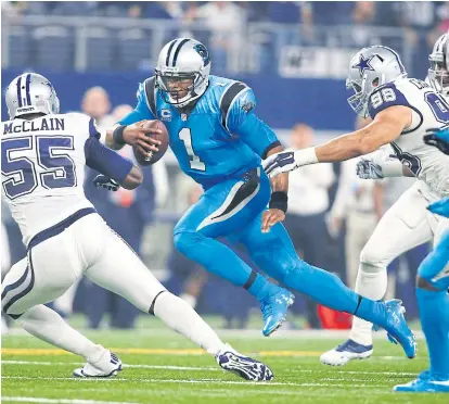  ??  ?? Panthers quarterbac­k Cam Newton, centre, runs the ball against the Cowboys during the second quarter.