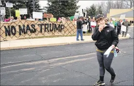  ?? JEREMY WADSWORTH / THE (TOLEDO) BLADE ?? Katie Finneran of Columbus leads a chant during a protest against Sen. Rob Portman on Wednesday at Terra State College in Fremont. Protesters were opposed to immigratio­n policies proposed by President Donald Trump.