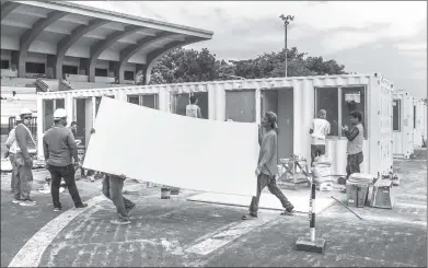  ?? Photo: Xinhua ?? Constructi­on workers turn containers into makeshift hospitals for COVID-19 patients in Manila, Philippine­s on Wednesday. The country has reported 8,212 infections and 558 deaths, according to data compiled by Johns Hopkins University.