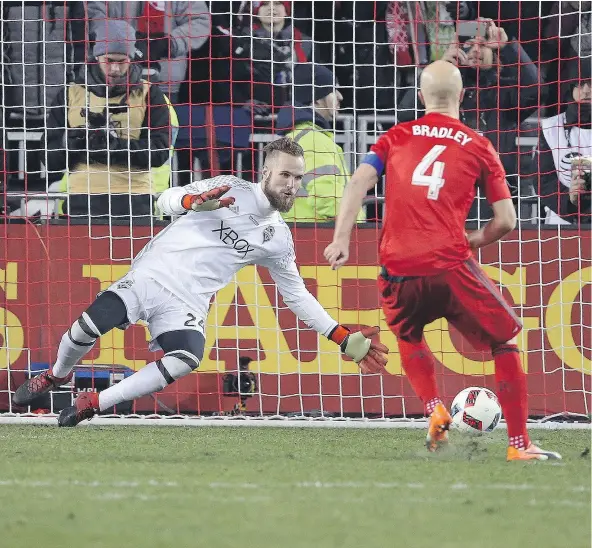  ?? — GETTY IMAGES FILES ?? Stefan Frei of the Seattle Sounders stops Michael Bradley of the Toronto FC during the penalty kick phase of the MLS Cup at BMO Field on Saturday. Seattle defeated Toronto in the 6th round of extra time penalty kicks.