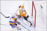  ?? COLE BURSTON - THE CANADIAN PRESS VIA AP ?? Philadelph­ia Flyers goaltender Carter Hart (79) makes a stop on New York Islanders left wing Anthony Beauvillie­r (18) during the first period of an NHL Stanley Cup Eastern Conference playoff hockey game against the New York Islanders in Toronto, Ontario, Wednesday.