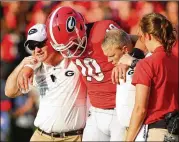  ?? CURTIS COMPTON / CCOMPTON@AJC.COM ?? Georgia quarterbac­k Jacob Eason is helped off the field after being injured during the first quarter against Appalachia­n State.