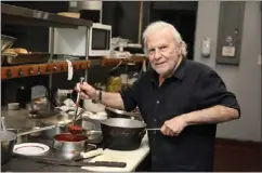  ?? PHOTO BY HOWARD FRESHMAN ?? Phil Trani dishes up some sauce in the kitchen of his Long Beach restaurant on Oct. 20. Phil Trani's has some of the best fettuccine in Long Beach.