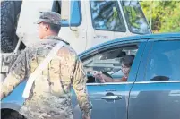  ?? MARCO GARCIA/THE ASSOCIATED PRESS ?? Hawaii Gov. David Ige called in the U.S. National Guard to help with evacuation­s. More than 1,500 people have had to flee.