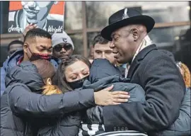  ?? Kerem Yucel AFP /Getty Images ?? DAUNTE WRIGHT’S family hugs lawyer Benjamin Crump, right, outside the county courthouse in Minneapoli­s. A few dozen protesters later held a march.