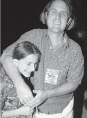  ?? MANNY HERNANDEZ Miami Herald file photo ?? File photo of writer Tom Austin with his daughter Claire at an N’Sync concert in South Beach in 2001.