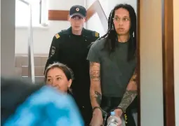  ?? ALEXANDER ZEMLIANICH­ENKO/AP ?? Mercury star and two-time Olympic gold medalist Brittney Griner is escorted to a courtroom Monday near Moscow for a preliminar­y hearing.