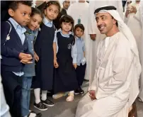  ?? — Photos by Ryan Lim and Wam ?? A visitor checking books; and (right) Shaikh Abdullah bin Zayed Al Nahyan, Minister of Foreign Affairs and Internatio­nal Cooperatio­n, shares some lighter moments with children at the Abu Dhabi Internatio­nal Book Fair.