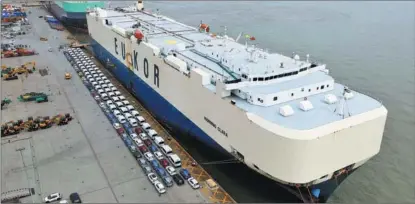  ?? FANG ZHE / XINHUA ?? Vehicles made by SAIC Motor, based in Shanghai, wait to be exported at a port in the city.