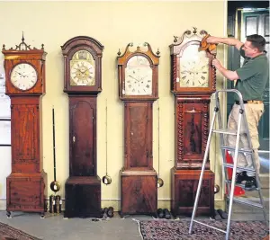  ?? Picture: Kris Miller. ?? Saleroom porter Gordon Christie polishes the clocks before the sale.