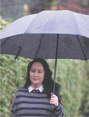  ?? JONATHAN HAYWARD / THE CANADIAN PRESS ?? Chief financial officer of Huawei Meng Wanzhou leaves her home Monday
in Vancouver to attend her extraditio­n hearing in B.C. Supreme Court.