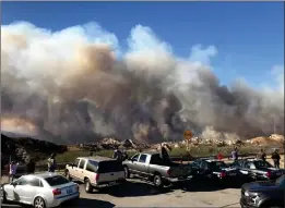  ?? Austin Dave/ The Signal (See additional photos at signalscv.com) ?? Spectators watched as the Rye Fire burned more than 6,000 acres in December 2017. Those who had property affected by the fire are likely eligible to receive help on property taxes they owe, per county officials.