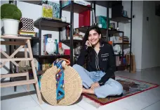  ??  ?? Anum Bashir, pictured in her living room with an oversized Aranaz bag, decorated with an Hermès scarf