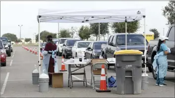  ?? The Monitor photo via AP ?? Health officials and members of the military assist during COVID-19 testing Wednesday at HEB Park in Edinburg, Texas.