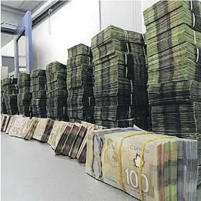 ??  ?? Police displayed more than $1 million in cash seized during the raid.