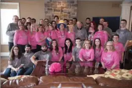  ??  ?? Jeanne’s friends and family surprised her by wearing matching T-shirts. The colours are synonymous with brain cancer (grey with pink). The back of the T-shirt reads: “Feed your faith, starve your doubt, conquer your fear, and remember, we are together...