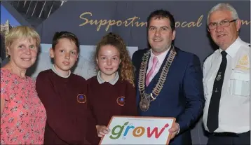  ??  ?? Mary McDonnell, Tidy Towns and pupils from St. Mochta’s NS Louth Village receive their GROW 4 Star award from Cllr. Liam Reilly, Chairman of LCC watched by Litter warden, Eugene Birch at the Louth Local Authoritie­s GROW Awards held in the Crowne Plaza.