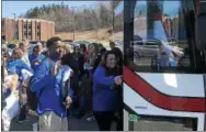  ??  ?? Cameron Newman waves goodbye to his family Friday morning at Columbia High School as he climbs aboard a bus that will take him and his classmates on the first leg of a 10-day trip to Europe.