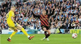  ?? Picture: PAUL CHILDS / REUTERS ?? PILING ON PRESSURE: Manchester City’s Phil Foden scores against Brighton and Hove Albion at The American Express Community Stadium, Brighton, on Wednesday