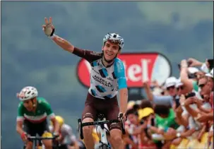  ?? The Associated Press ?? FRENCH FAVORITE: Frenchman Romain Bardet celebrates as he wins Stage 12 of the Tour de France, a 133.3-mile segment Thursday. Italian Fabio Aru, left, finished second and took the overall lead from three-time Tour champion Chris Froome of Great Britain.