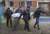  ?? Efrem Lukatsky Associated Press ?? WORKERS recover victims’ bodies after the helicopter crashed in a foggy suburb of Ukraine’s capital.