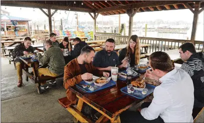  ?? DANA JENSEN THE DAY ?? A group from Denver, Colo., lunches Thursday at Captain Scott’s Lobster Dock in New London. The group spends a lot of time in the area and goes to Captain Scott’s every time they’re in the city.