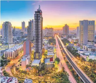  ??  ?? GO WEST: The Bangkok skyline from Krung Thon Buri.