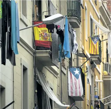  ?? EMILIO MORENATTI/ AP ?? Balconies decorated with Esteladas, or pro independen­ce flags, and also a Spanish flag are seen in Barcelona on Wednesday. Spain’s deputy prime minister says the government has requested the country’s constituti­onal court to nullify a parliament­ary...