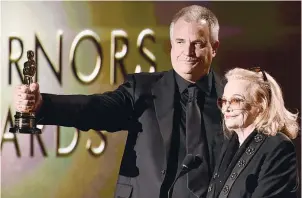  ??  ?? Gena Rowlands looks on as her son Nick Cassavetes holds her award.