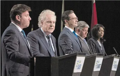  ?? ADRIAN WYLD THE CANADIAN PRESS ?? Conservati­ve leadership candidates Roman Baber, left, Pierre Poilievre, Scott Aitchison and Leslyn Lewis listen to Jean Charest, second from left, speak during a debate at the Canada Strong and Free Network conference last week.