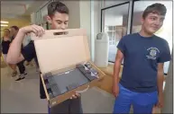  ?? Erik Trautmann / Hearst Connecticu­t Media file photo ?? Incoming Brien McMahon High School freshmen including Bejamn Conte and Zachary DiMeglio receive their Chromebook­s in 2018, as part of the Norwalk Public Schools 1:1 Digital Learning Initiative.