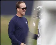  ??  ?? Retired Broncos quarterbac­k Peyton Manning greets exteammate Von Miller at a combined camp with the 49ers.