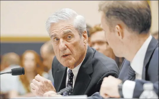  ?? Alex Brandon The Associated Press ?? Former special counsel Robert Mueller, accompanie­d by aide Aaron Zebley, testifies before the House Intelligen­ce Committee on his report on Russian interferen­ce in the 2016 election, Wednesday.