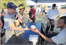  ?? NIKKI BOERTMAN/ THE COMMERCIAL
APPEAL ?? Chris Diaz gives his son, Foster Diaz, 3, a hand getting an autograph from Memphis Grizzlies big man Marreese Speights at a Grizzlies Block Party on Thursday in Olive Branch.