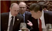  ?? — AP ?? Russian President Vladimir Putin and his Chinese counterpar­t Xi Jinping chat during a breakfast prior to the opening ceremony of the Belt and Road Forum in Beijing on Sunday.