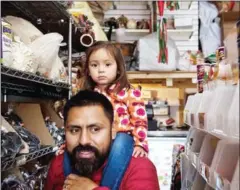  ?? HILARY SWIFT/THE NEW YORK TIMES ?? Ana with her father, Irvi Cruz, as they buy soda water at a Mexican market down the street from their Harlem apartment.