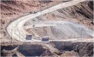  ?? `ROBERTO E. ROSALES/JOURNAL ?? Vehicles move dirt and rocks along a road leading into an open-pit copper mine at Bayard, N.M.