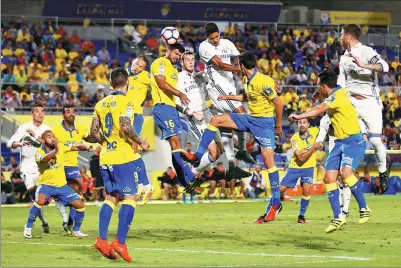  ?? BORJA SUAREZ / REUTERS ?? Real Madrid's Raphael Varane heads the ball during his team’s match against Las Palmas. The matche ended in 2-2 draw.