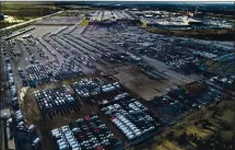  ?? JEFF ROBERSON — THE ASSOCIATED PRESS ?? A General Motors assembly plant is seen at top right while mid-size pickup trucks and full-size vans currently produced at the plant are seen in a parking lot outside on March 24 in Wentzville, Missouri.