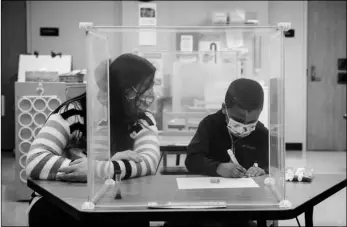  ?? Via AP
Ashlee Rezin Garcia/Chicago Sun-Times ?? In this Jan. 11 file photo, pre-kindergart­en teacher Sarah McCarthy works with a student at Dawes Elementary in Chicago.