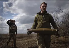  ?? EFREM LUKATSKY — THE ASSOCIATED PRESS FILE ?? Ukrainian soldiers carry shells to fire at Russian positions on the front line, near the city of Bakhmut, in Ukraine’s Donetsk region, on March 25.
